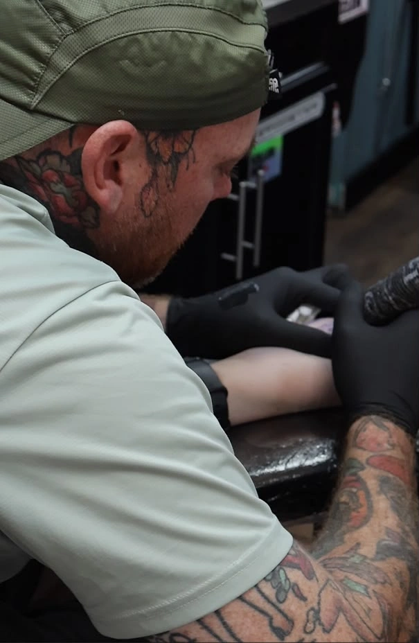 Tattoo artist Danny working on a client