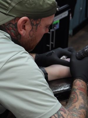Tattoo artist Danny working on a client